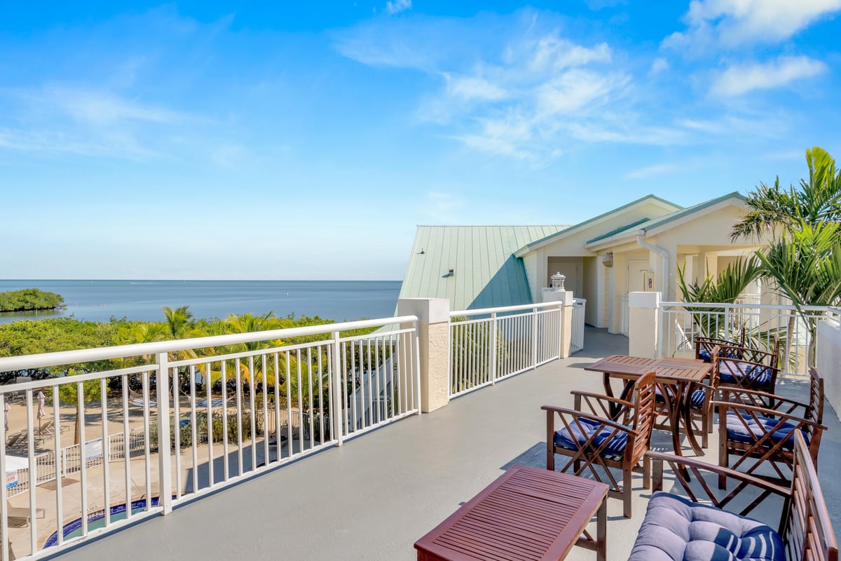 Dove Creek Resort & Marina rooftop terrace above the beach, loungers facing the open Atlantic